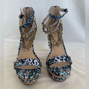 Platform sandal with abstract print and straps with gold chain and rhinestones.